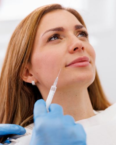 Doctor applying hyaluron fillers to patient